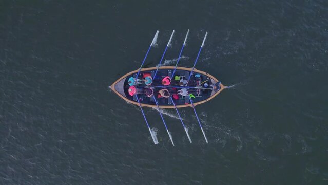Cornwerd, Netherlands - 28 August 2023: Aerial view of rowing team in boat during training on the lake during sunset, Ijsselmeer, Netherlands