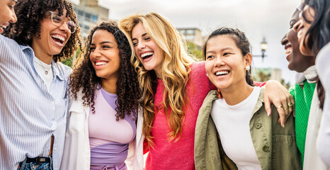 Multi ethnic group of young women hugging outside - Happy girlsfriends having fun laughing out loud on city street - Female community concept with cheerful girls standing together - Women  power - 758889860