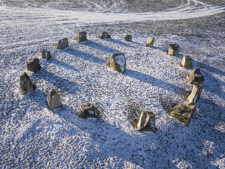 Aerial view of stone circle in snow. Area of positive energy in Bohemian countryside. Standing stones also known as czech stonehenge on Hujab hill, Bohemia.