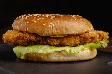 Fried chicken sandwich with lettuce and mayonnaise on sesame seed bun