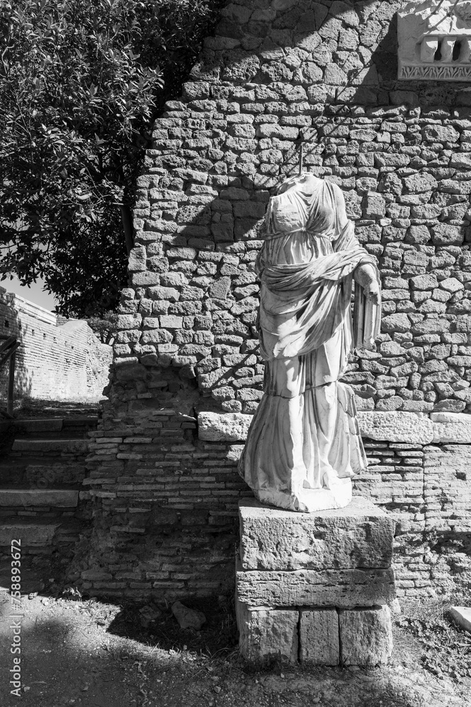 Wall mural Black and white photo of roman statue in the archaeological site of Ancient Ostia in Italy