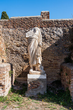 Ruins of roman statue in the archaeological site of Ancient Ostia in Italy