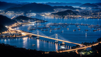 An overhead view shows a bridge spanning a vast body of water, connecting two landmasses. The bridges structure, pillars, and length are visible, contrasting against the shimmering water below - obrazy, fototapety, plakaty
