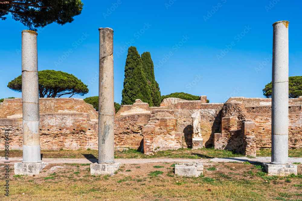 Wall mural Sequence of three pillars in ruins in ancient Ostia archaeological park in Italy