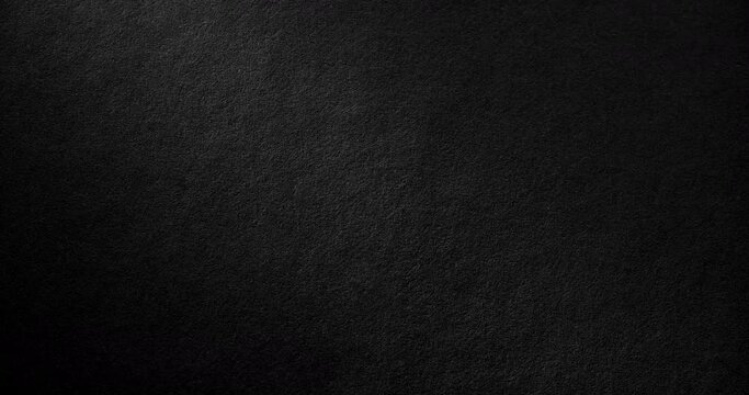 Texture of velvet black paper. Surface of black rough paper, slowly rotating. Use for background and texture.
