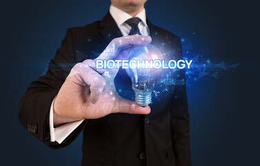 Businessman holding a light bulb