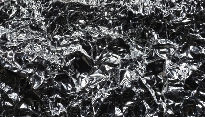 Glare surface. Wrinkled foil. Crumpled background. Selective focus