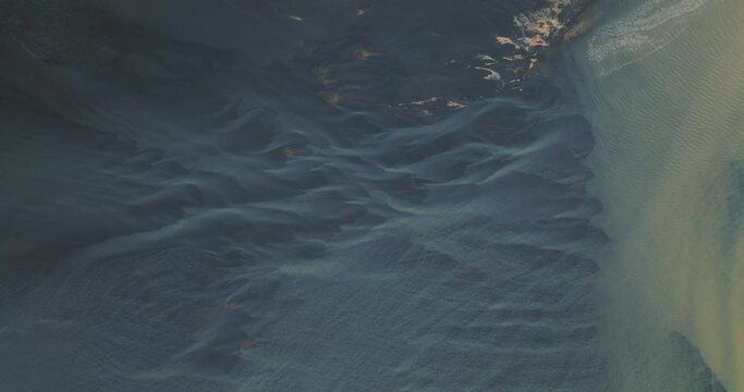 Aerial view of glacier river and sand textures in Iceland.