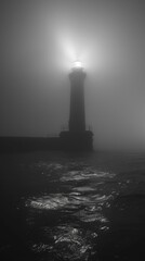 Solitary lighthouse beam cutting through the fog
