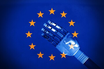 European flag with a robot hand in the center, concept of Ai regulation in Europe.