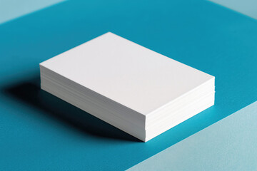 Stack of white paper isolated on blue background, mockup.