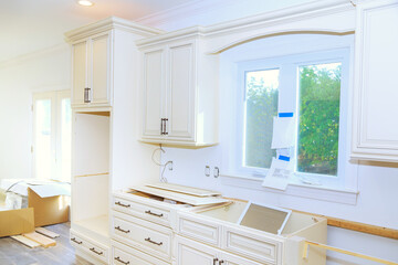Installing new white kitchen cabinets as home improvement project