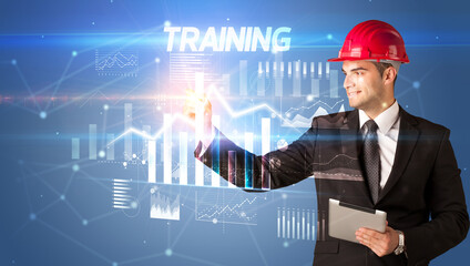 Young businessman with helmet drawing on virutal screen