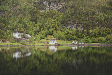 reflection of a house in the lake in the mountains 