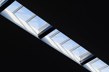 Ceiling windows in a row with bright blue sky
