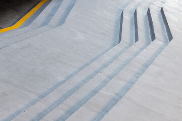 Gray concrete stairs with yellow line in the beginning