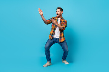Full size photo of handsome young male fighting pose karate nervous wear trendy plaid outfit...