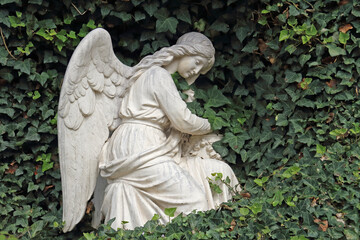 an angel statue made from a light stone