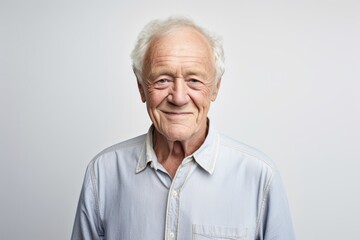 Portrait of a smiling senior man. Isolated on gray background.