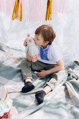 Fototapeta premium Easter celebration, Child in nature with Easter cake and eggs and Easter decor