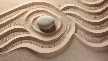 Fototapeta na wymiar Japanischer Garten mit einem großen Krieselstein und Wellen im Sand