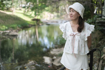 portrait asian woman relax in tropical nature near stream