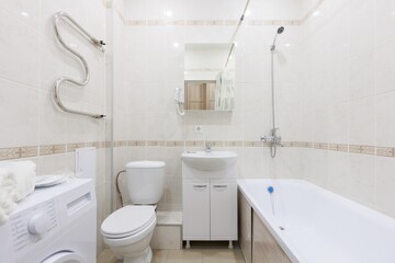 modern bathroom room with toilet and washing machine
