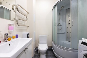modern bathroom room with toilet and washing machine