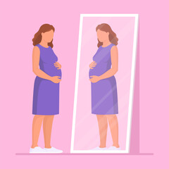 Pregnant woman looking at herself in the mirror