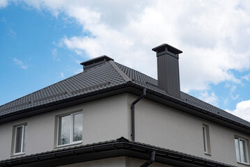 House with gray plastic rain gutter system