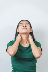 Happy and calm Asian girl is seen enjoying a pleasant aroma, taking deep breaths of fresh air in isolation.