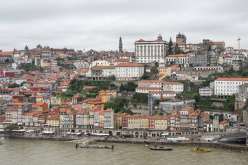 Fototapeta na wymiar View of Porto city at the riverbank (Ribeira quarter) and Porto Cathedral, Portugal, a UNESCO World Heritage City.