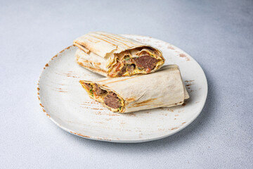 Traditional mexican quesadilla with meat on white plate