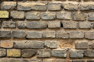 Old brutal brick wall. Yellow, brown, black colors. Background for design.