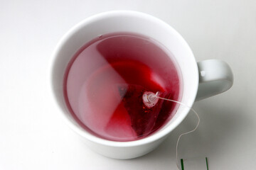 red hot tea in a beautiful mug on a white background