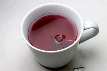 red hot tea in a beautiful mug on a white background