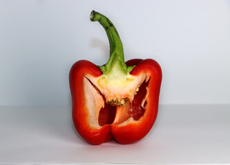 sliced ​​fresh and fresh red bell pepper on a white background