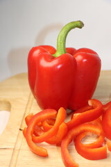 sliced ​​fresh red bell pepper on a wooden cutting board
