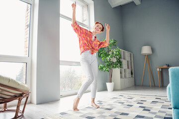 Full body photo of pretty positive lady dancing barefoot spend pastime spacious modern apartment...