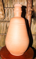 Fototapeta na wymiar A bulging earthenware container for storing water, with a short, narrow neck, popularly called a Bilha, Moringa or Quartinha.