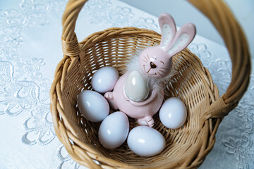Easter bunny with eggs in a basket with willow