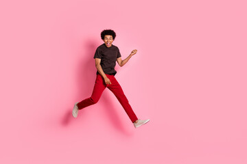 Fototapeta na wymiar Full body length photo of hipster guy jumping holding solo electro guitar musician rock roll concert isolated on pink color background
