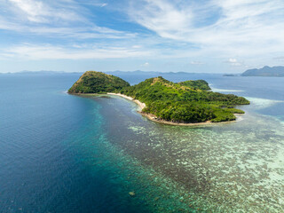 Tropical Island with sandy beach in coastline. Coral reefs around Dimanglet Island in Coron, Palawan. Philippines.