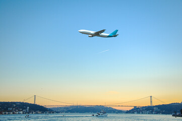 Passenger plane flying over the Bosphorus of Istanbul.
