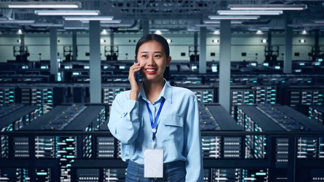 Asian Business Woman Talking On Mobile Phone In Data Center