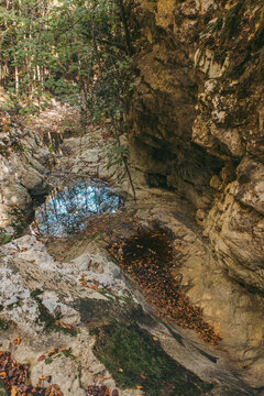 Canyon of a dried river with lots of rocks, foliage and trees during autumn, river Derventa, Uzice, Serbia