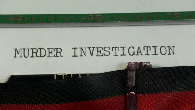 Report of an investigation into a murder. Typing Murder Investigation on an old manual typewriter.