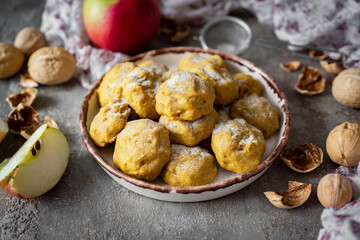 Pumpkin cookies with apples and nuts for breakfast. Sweet dessert: sweet cookies with nuts. Close-up