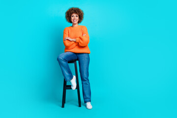 Full body photo of positive stunning lady sit stool folded arms empty space ad isolated on teal...