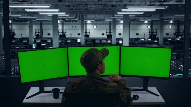 Back View Of Asian Military Thinking About Something While Working With Mock Up Multiple Computer Monitor In Data Center
